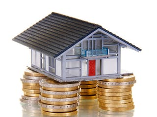 Grundstueckspreis Haus auf Geldmünzen Grundstueckspreis Haus auf Geldmünzen